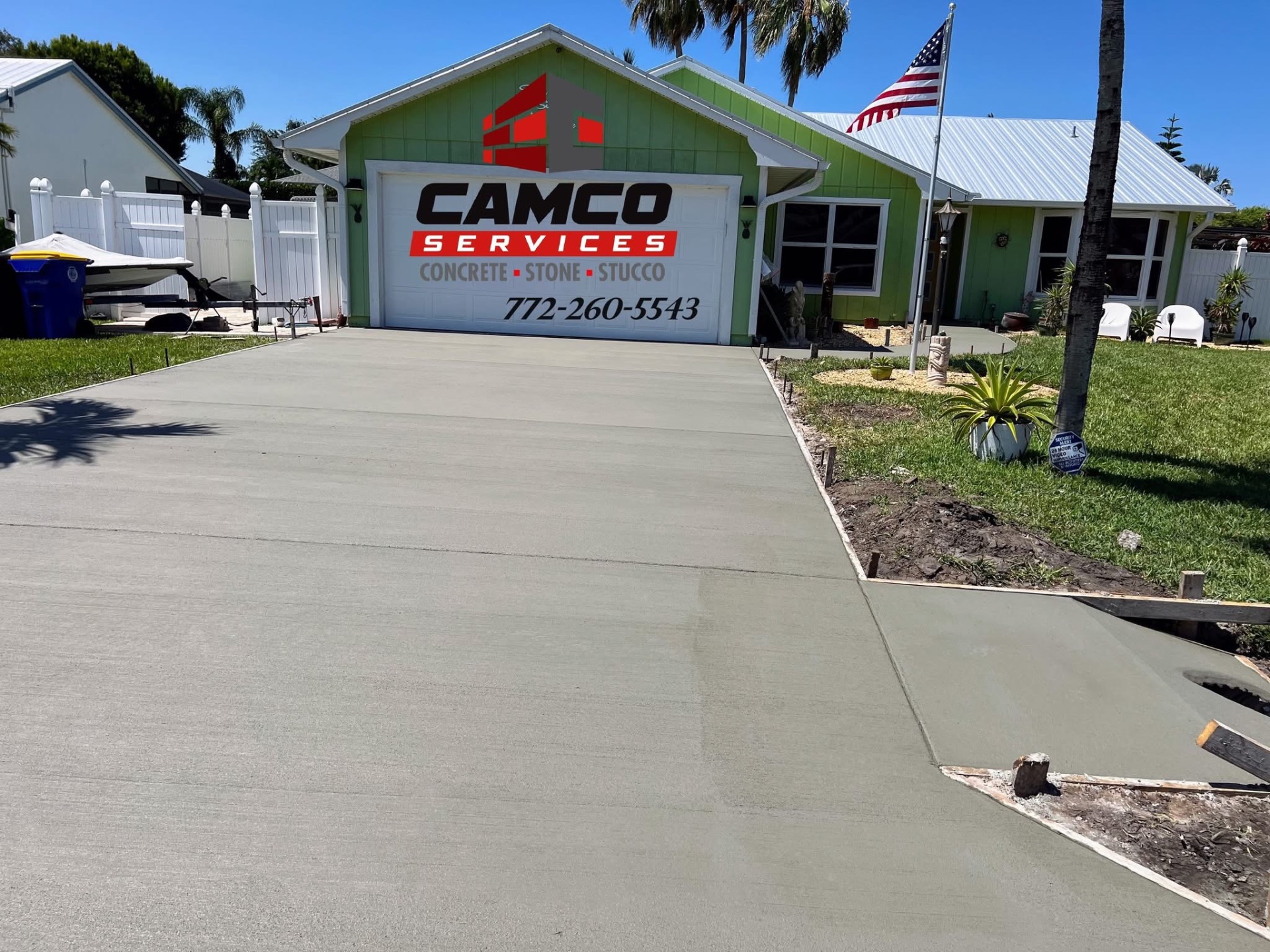 Broom-finished concrete driveway and side walkway at a green Florida home