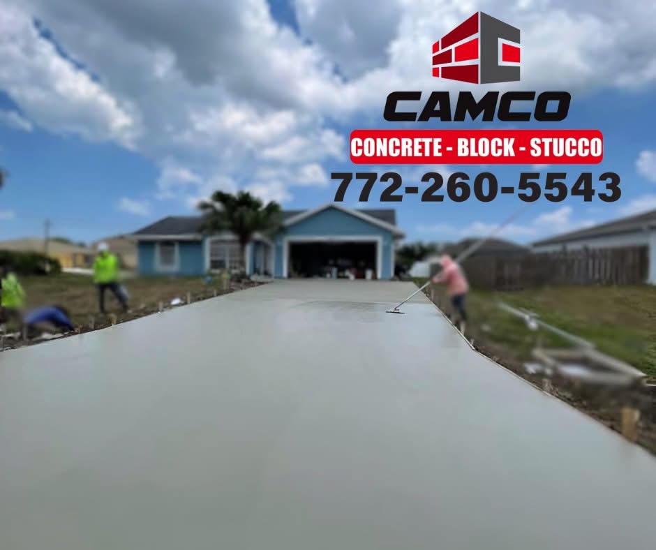 Wet concrete driveway pour being bull floated by the CAMCO crew